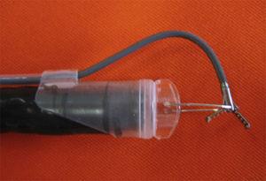EndoLifter, with the retractable grasping forceps attached to a transparent cap.