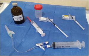 Material used for drainage and percutaneous injection of ethanol. Bottom: 21 G syringe, double-lumen extension connector, one for drainage and one for injection. Middle, from left to right: a syringe with ethanol, a syringe with saline for wash-out and a syringe with 0.5 ml of 5% lidocaine. Top: absolute ethanol for parenteral use and sterile bottle for the drained cystic fluid.
