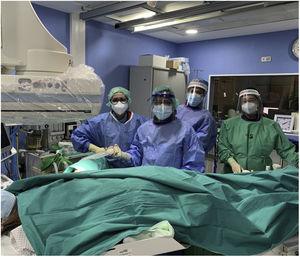 Interventional radiology team (radiologists, nurse and technician) wearing personal protective equipment.